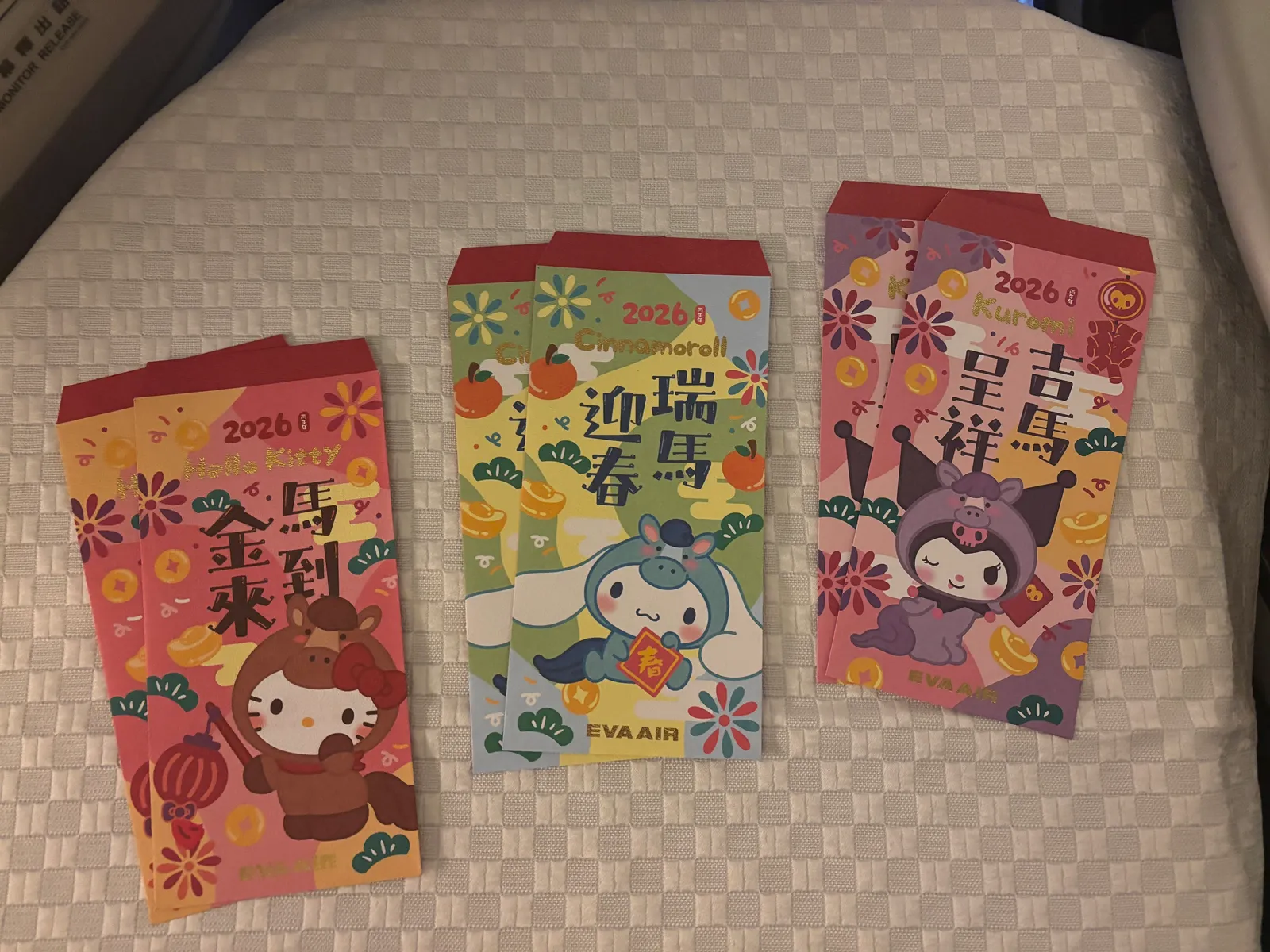 EVA Air 2026 Chinese New Year Sanrio red envelopes featuring Hello Kitty, Cinnamoroll, and Kuromi
